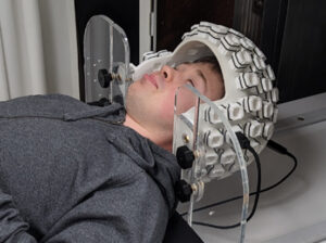 Picture of a man wearing a helmet equipped with sensors.